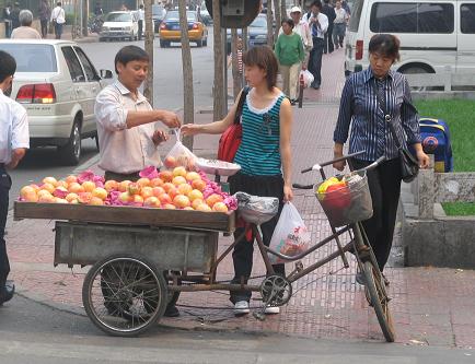 Man sells fruit on the street near my apartment